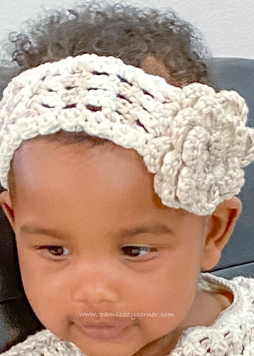 Ababywithcrochetheadbandonherhead